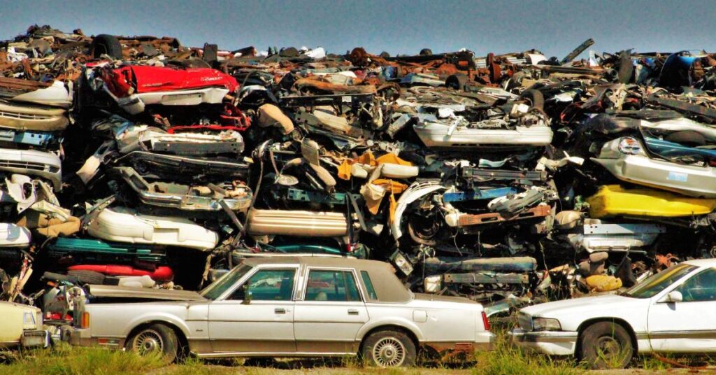 Countless old cars dumped in a junkyard.