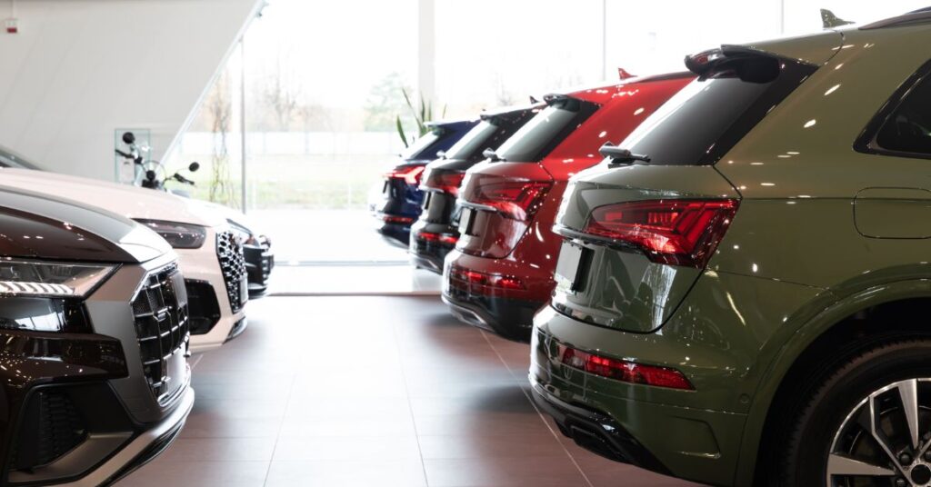 Row of SUV's with other cars behind them in a showroom